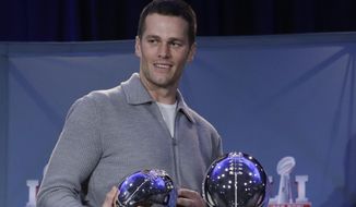 In this Feb. 6, 2017, file photo, New England Patriots quarterback Tom Brady walks off with his MVP trophy during a news conference after the NFL Super Bowl 51 football game in Houston. (AP Photo/Morry Gash, File)