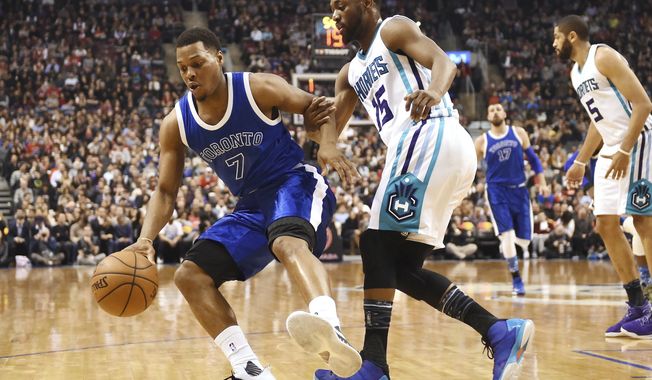 Charlotte Hornets guard Kemba Walker (15) defends Toronto Raptors guard Kyle Lowry (7) during the first half of an NBA basketball game Wednesday, Feb. 15, 2017, in Toronto. (Frank Gunn/The Canadian Press via AP)