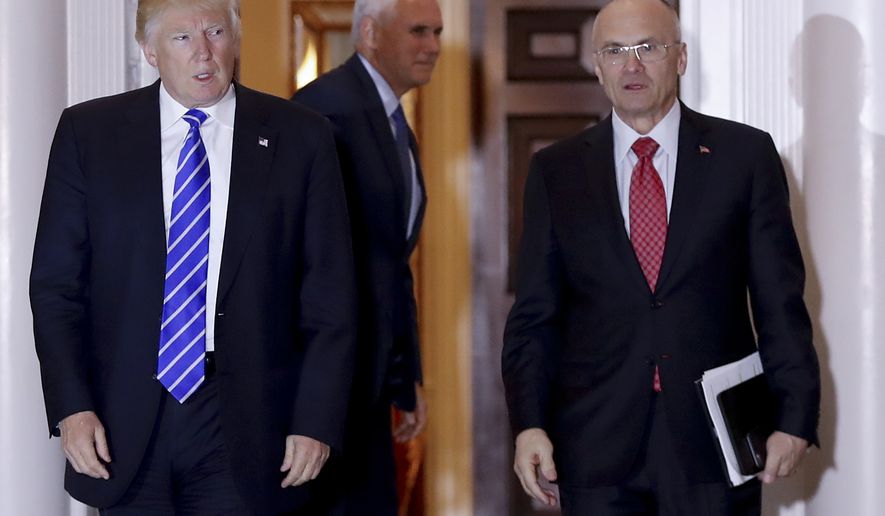 Then-President-elect Donald Trump walks Labor Secretary-designate Andy Puzder from Trump National Golf Club Bedminster clubhouse in Bedminster, N.J., in this Nov. 19, 2016, file photo. (AP Photo/Carolyn Kaster, File)