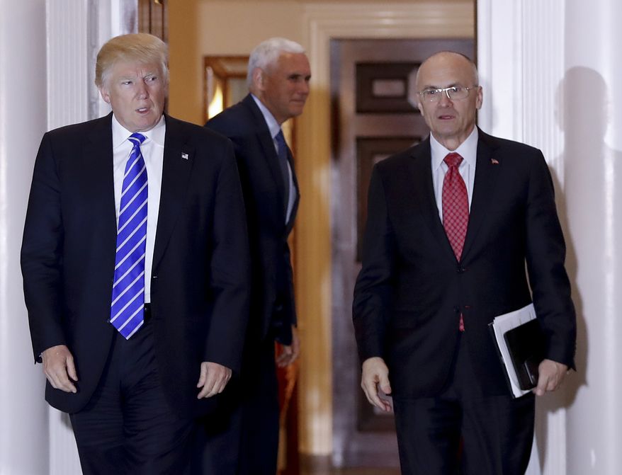 Then-President-elect Donald Trump walks Labor Secretary-designate Andy Puzder from Trump National Golf Club Bedminster clubhouse in Bedminster, N.J., in this Nov. 19, 2016, file photo. (AP Photo/Carolyn Kaster, File)