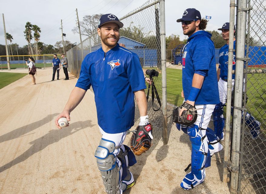Toronto Blue Jays catchers Russell Martin, left, and Jarrod Saltalamacchia, right, laugh during baseball spring training in Dunedin, Fla., Wednesday, Feb 15, 2017. (Nathan Denette/The Canadian Press via AP)