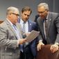 From left, Reps. Rick Edmonds, R-Baton Rouge; Tanner Magee, R-Houma; and Mark Abraham, R-Lake Charles, talk about budget cut proposals ahead of the House Appropriations Committee meeting, on Wednesday, Feb. 15, 2017, in Baton Rouge, La. (AP Photo/Melinda Deslatte)