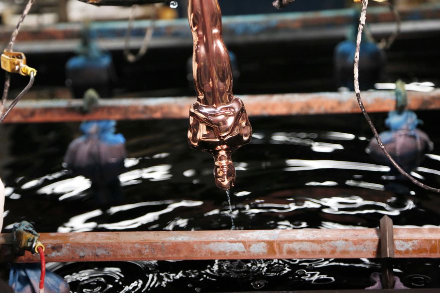 A copper plated Oscar statuette is run through a series of chemical baths at Epner Technology in the Brooklyn borough of New York, Tuesday, Jan. 17, 2017. Each statuette is coated in three layers - the final one the iconic gold - and every Oscar fist-pumped or tearfully cradled by Academy Award winners is first cast, buffed and fussed over by people far from Hollywood who have spent the last several months making 60 identical gold Oscars for the Feb. 26th awards. (AP Photo/Seth Wenig)