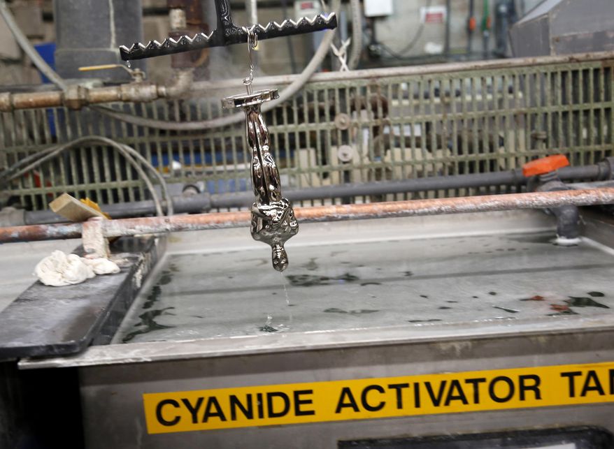 A nickel plated Oscar statuette is run through a series of chemical baths at Epner Technology in the Brooklyn borough of New York, Tuesday, Jan. 17, 2017. Each statuette is coated in three layers - the final one the iconic gold - and every Oscar fist-pumped or tearfully cradled by Academy Award winners is first cast, buffed and fussed over by people far from Hollywood who have spent the last several months making 60 identical gold Oscars for the Feb. 26th awards. (AP Photo/Seth Wenig)
