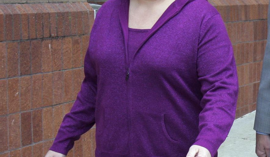 FILE - In this Nov. 12, 2012, file photo, Susan "Liz" Van Note walks outside the Clay County Courthouse in Liberty, Mo. Van Note, a suburban Kansas City attorney, was acquitted Tuesday night, Feb. 14, 2017, of two counts of first-degree murder in the 2010 deaths of her father, William Van Note and his girlfriend, Sharon Dickson. (Jim Barcus/The Kansas City Star via AP, File)