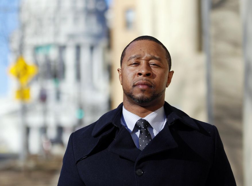 In this Monday, Feb. 13, 2017, photo, Jarrett Adams stands outside the Dane County Courthouse in Madison, Wis. Adam, who spent seven years in prison for a Wisconsin rape before he was cleared, is now an attorney with the Innocence Project in New York and is trying to clear another man of the same crime. Adams made his first appearance in a Dane County courtroom as an attorney during a hearing in that sexual assault case Tuesday, Feb. 14. (AP Photo/Carrie Antlfinger)
