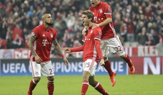 Bayern&#39;s Thomas Mueller, center, celebrates with his teammates Joshua Kimmich, right, and Arturo Vidal after scoring his side&#39;s fifth goal during the Champions League round of 16 first leg soccer match between FC Bayern Munich and Arsenal, in Munich, Germany, Wednesday, Feb. 15, 2017. (AP Photo/Matthias Schrader)