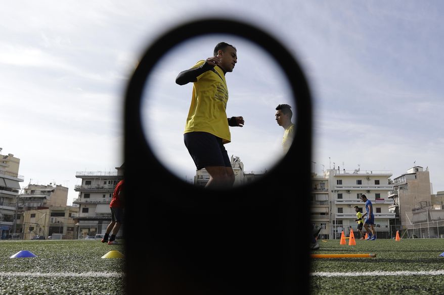 FOR STORY GREECE TEAM CALLED HOPE Greece Team Called Hope In this Wednesday, Feb. 1, 2017, players of Hope Refugee Football Club practice during a training in Athens. The team is called "Hope" and is made up of players who fled warzones like Syria, Yemen, Iraq and Afghanistan. (AP Photo/Thanassis Stavrakis)