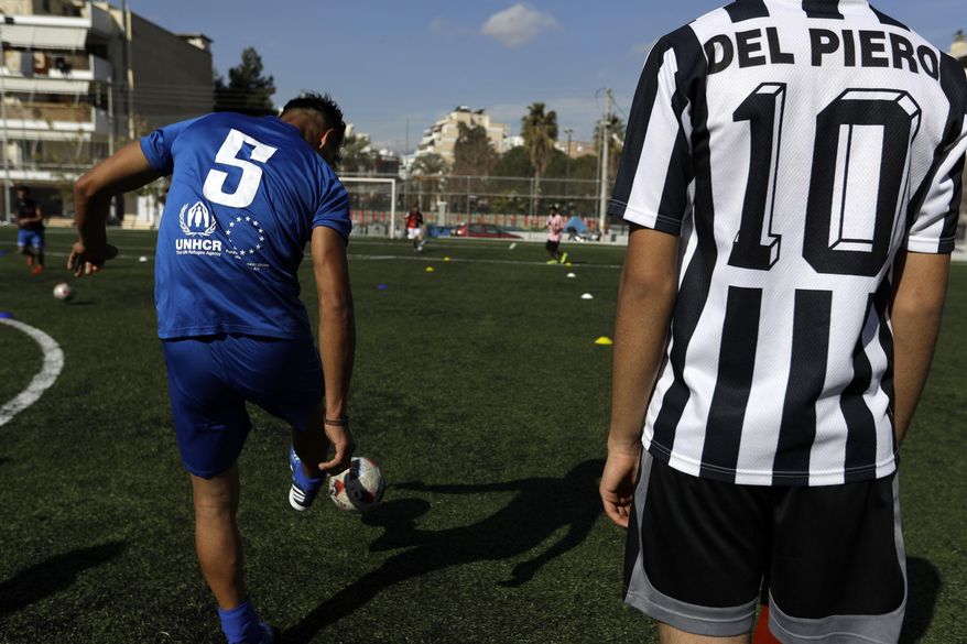 FOR STORY : GREECE TEAM CALLED HOPE: Greece Team Called Hope In this Friday, Feb. 3, 2017, players of Hope Refugee Football Club play with the ball during a training in Athens. Former Greek national soccer team goalkeeper Antonis Nikopolidis, who became a national hero in 2004 during the European Cup, is heading a project to help refugees stranded in Greece regain a sense of purpose, working as a team. The team is called "Hope" and is made up of players who fled warzones like Syria, Yemen, Iraq and Afghanistan. (AP Photo/Thanassis Stavrakis)