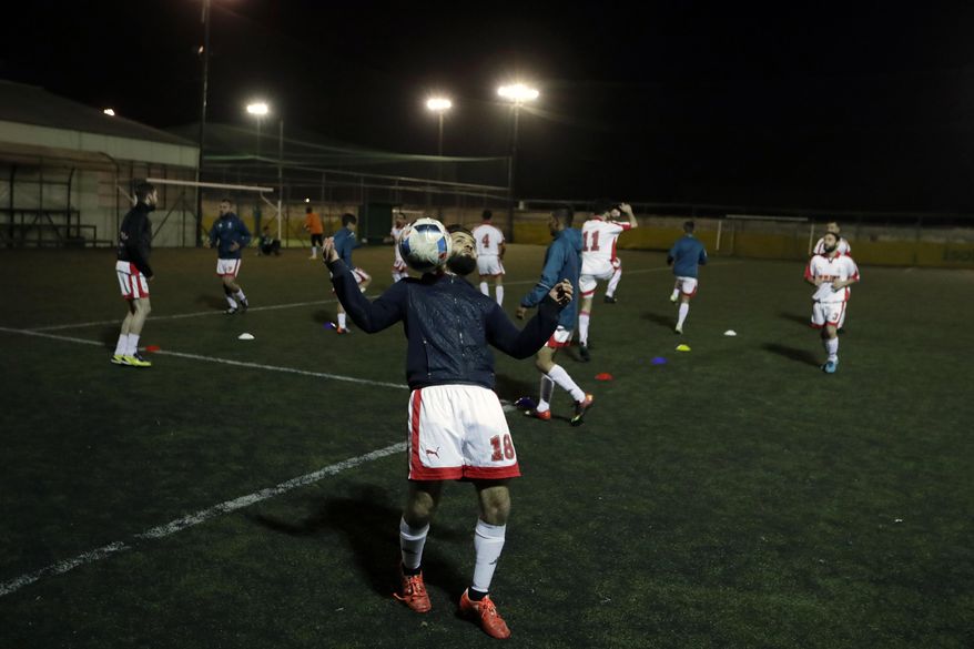 FOR STORY: GREECE TEAM CALLED HOPE - In this Sunday, Feb. 5, 2017, a player of Hope Refugee Football Club controls the ball before a soccer match in western Athens. Former Greek national soccer team goalkeeper Antonis Nikopolidis, who became a national hero in 2004 during the European Cup, is heading a project to help refugees stranded in Greece regain a sense of purpose, working as a team. On Sundays they play in an amateur league against teams made up of professional groups like lawyers, telecom workers, and accountants. (AP Photo/Thanassis Stavrakis)