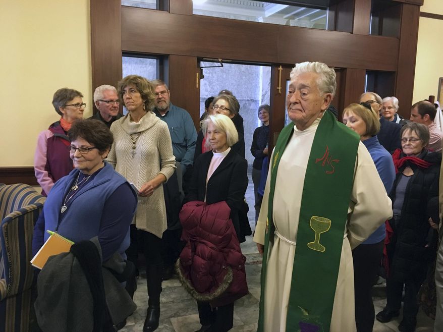 Clergy and other faith leaders stand in Gov. C.L. "Butch" Otter's office in Boise, Idaho, Wednesday, Feb. 15, 2017. Nearly 30 faith representatives delivered a letter to Otter urging the Republican to welcome all refugees and not just give preference to persecuted Christians. (AP Photo/Kimberlee Kruesi)