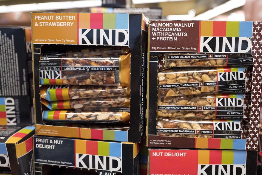 Kind snack bars are displayed in a New York supermarket, Thursday, Feb. 9, 2017. Kind CEO Daniel Lubetzky is pledging $25 million over the next 10 years to create a nonprofit dedicated to “revealing and countering” the food industry’s influence on public health. The move underscores the division between “Big Food” companies and newer players that market themselves as wholesome alternatives aligned with public health. (AP Photo/Mark Lennihan)