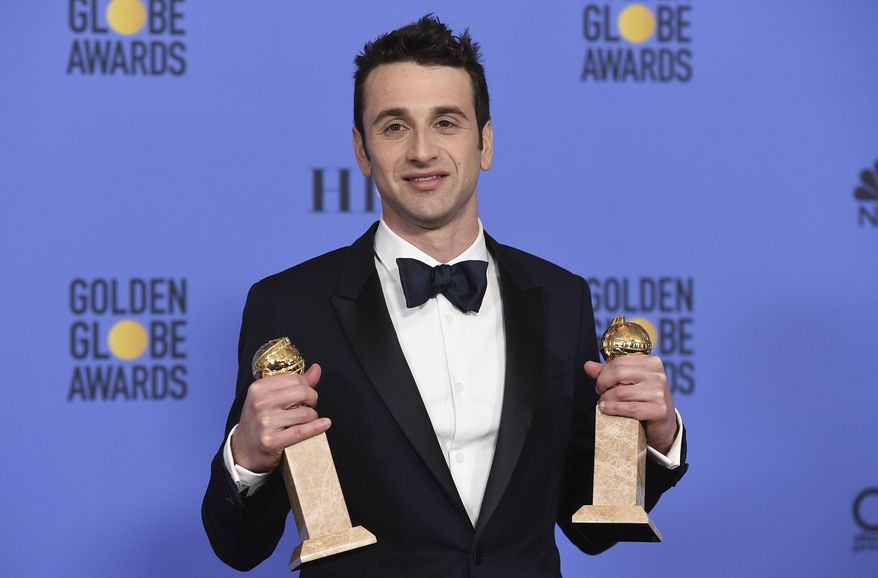 FILE - This Jan. 8, 2017 file photo shows Justin Hurwitz in the press room with the award for best original song for motion picture for "City Of Stars" and best original score - motion picture for "La La Land" at the 74th annual Golden Globe Awards in Beverly Hills, Calif. For Hurwitz, it’s been a long, laborious ride from dreaming up the musical “La La Land” with his old college roommate Damien Chazelle over six years ago to becoming the toast of awards season. He has won a handful of critics’ awards, a BAFTA and two Golden Globe Awards and is nominated for three Oscars, one for best score and two for best song. (Photo by Jordan Strauss/Invision/AP, File)