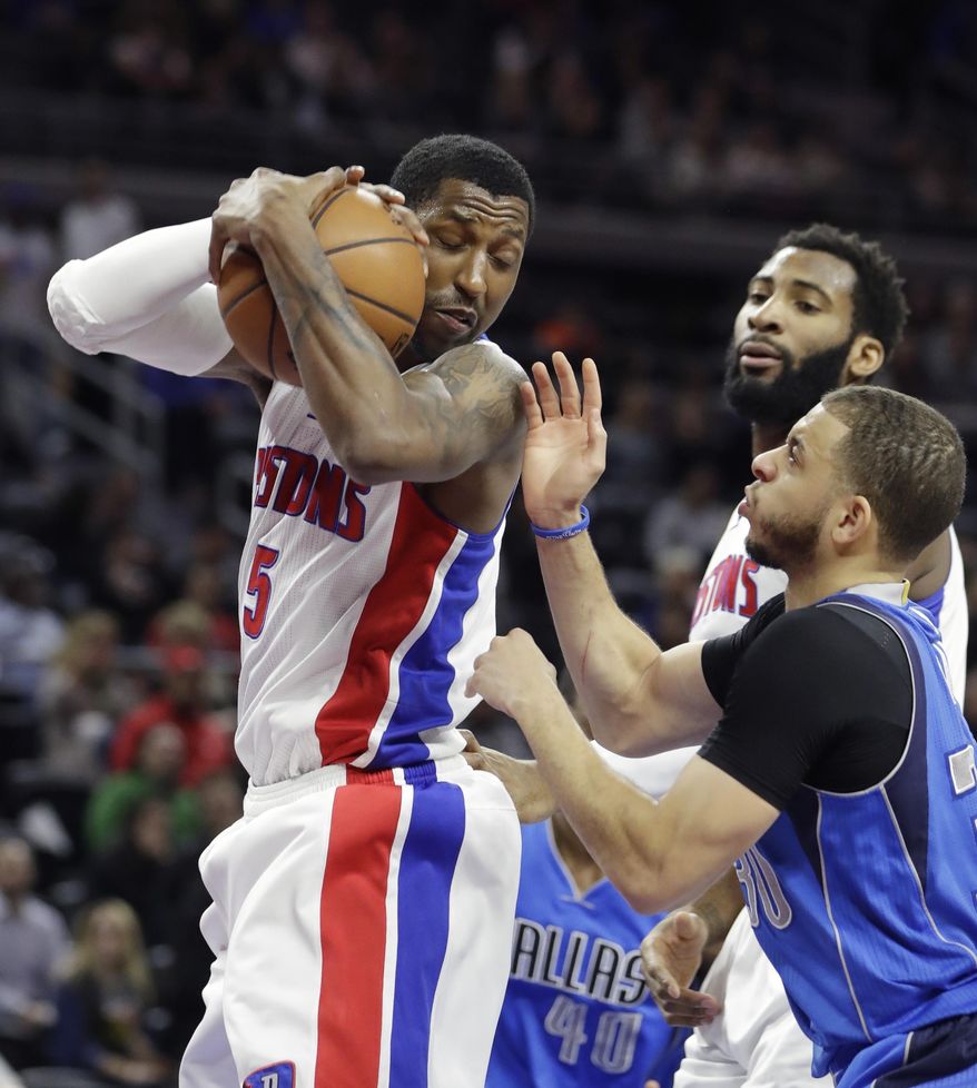 Detroit Pistons guard Kentavious Caldwell-Pope (5) grabs a rebound next to Dallas Mavericks guard Seth Curry during the first half of an NBA basketball game, Wednesday, Feb. 15, 2017, in Auburn Hills, Mich. (AP Photo/Carlos Osorio)