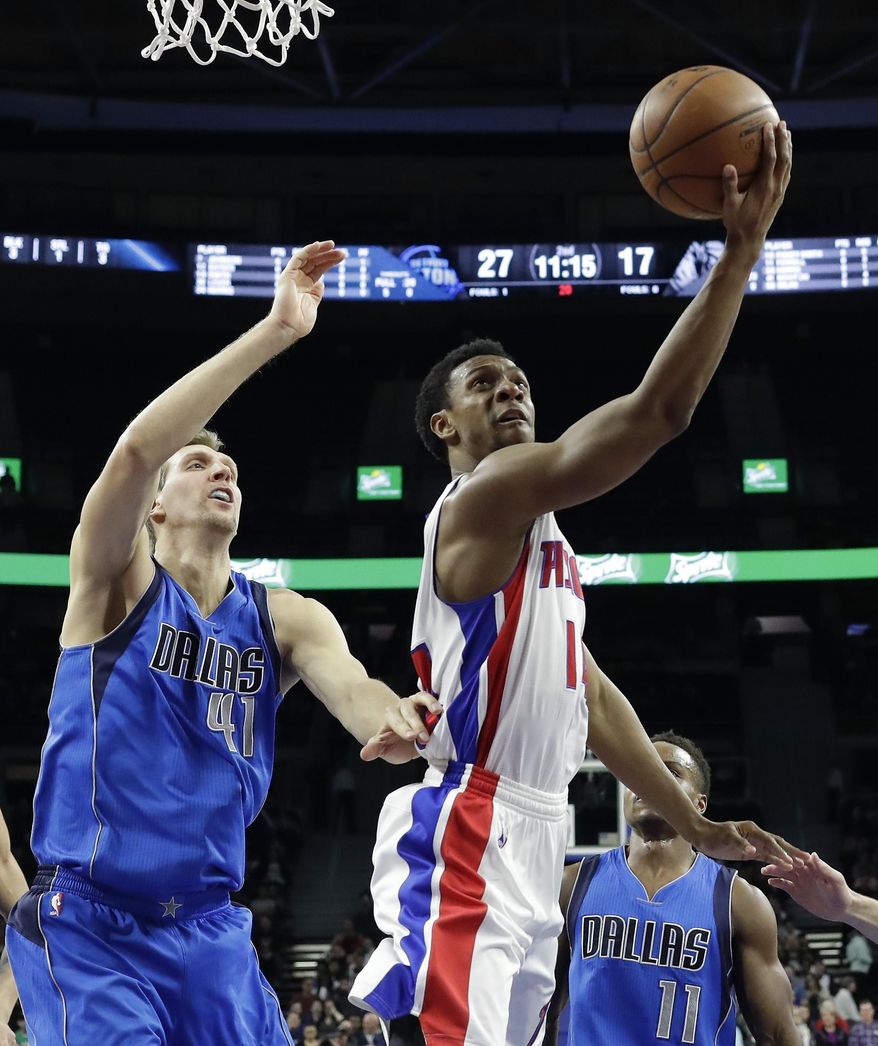Detroit Pistons guard Ish Smith makes a layup defended by Dallas Mavericks forward Dirk Nowitzki (41) during the first half of an NBA basketball game, Wednesday, Feb. 15, 2017, in Auburn Hills, Mich. (AP Photo/Carlos Osorio)