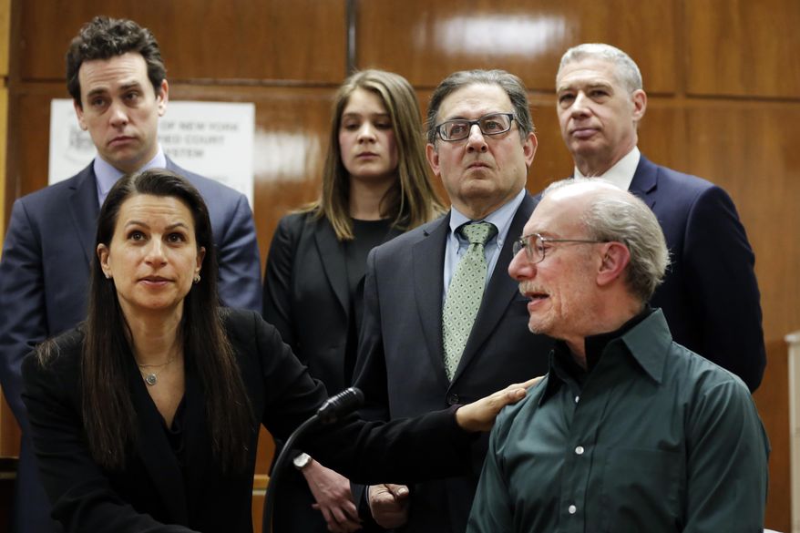 Stan Patz, right, father of 6-year-old Etan Patz who disappeared on the way to the school bus stop 38 years ago, is touched by Assistant District Attorney Karen Agnifilo, foreground left, after Pedro Hernandez was convicted of killing the boy, Tuesday, Feb. 14, 2017, in New York's Manhattan Supreme Court. (AP Photo/Richard Drew)