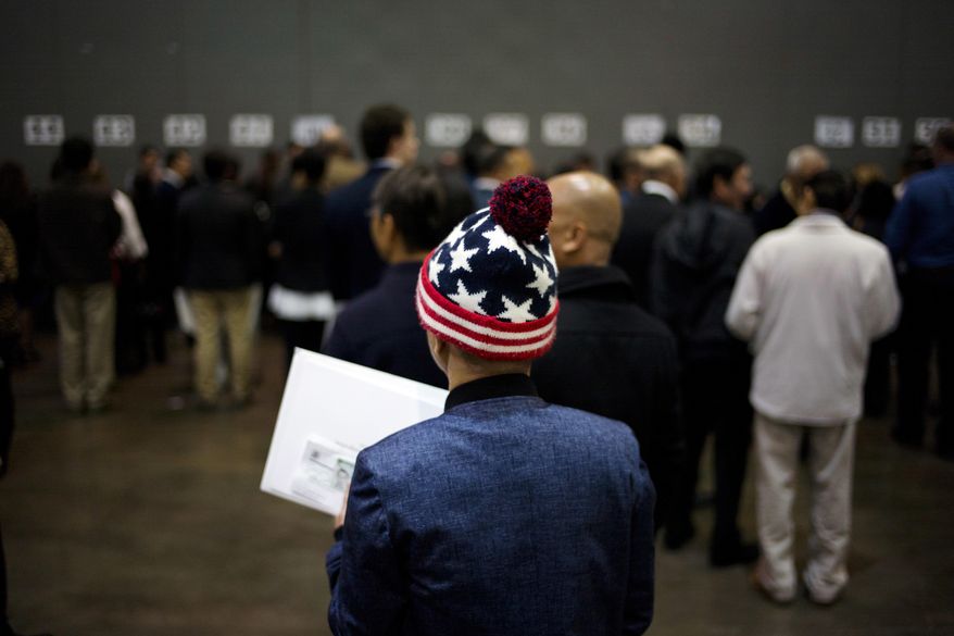 Vietnamese immigrant Tai Phu waits in line to pick up his U.S. citizenship certificate at a naturalization ceremony at the Los Angeles Convention Center, Wednesday, Feb. 15, 2017, in Los Angeles. About 3,000 people took the oath in the morning and more than 3,500 others were expected during an afternoon ceremony, according to U.S. Citizenship and Immigration Services officials.(AP Photo/Jae C. Hong)