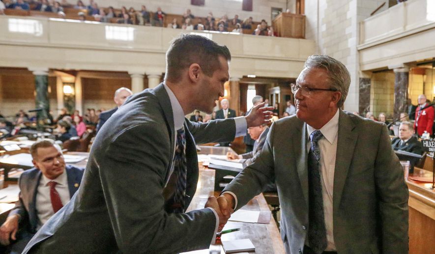 In this Jan. 4, 2017 photo, Neb. state Sen. Tyson Larson of O'Neill, left, congratulates Sen. Jim Scheer of Norfolk upon being elected as Speaker of the Unicameral, in Lincoln, Neb. Thirty days after they convened, Nebraska lawmakers are still spinning their wheels over parliamentary rules in what's shaping up to be one of the least productive legislative sessions in state history. Lawmakers on Wednesday, Feb. 15 will have burned through one-third of the days available for debate but have only passed two bills so far. (AP Photo/Nati Harnik)
