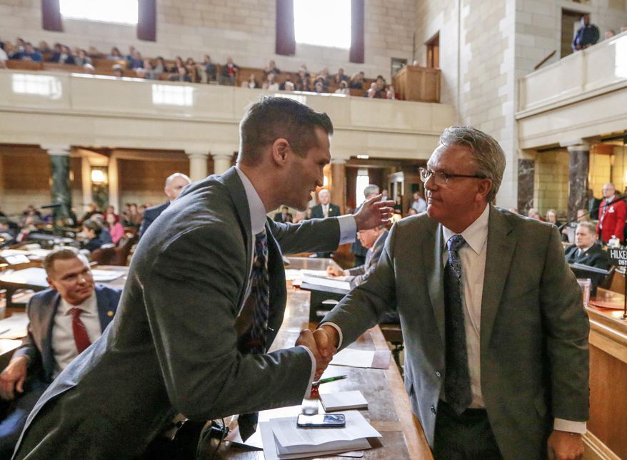 In this Jan. 4, 2017 photo, Neb. state Sen. Tyson Larson of O'Neill, left, congratulates Sen. Jim Scheer of Norfolk upon being elected as Speaker of the Unicameral, in Lincoln, Neb. Thirty days after they convened, Nebraska lawmakers are still spinning their wheels over parliamentary rules in what's shaping up to be one of the least productive legislative sessions in state history. Lawmakers on Wednesday, Feb. 15 will have burned through one-third of the days available for debate but have only passed two bills so far. (AP Photo/Nati Harnik)