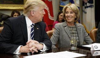 President Donald Trump looks at Education Secretary Betsy DeVos as he speaks during a meeting with parents and teachers, Tuesday, Feb. 14, 2017, in the Roosevelt Room of the White House in Washington. (AP Photo/Evan Vucci)