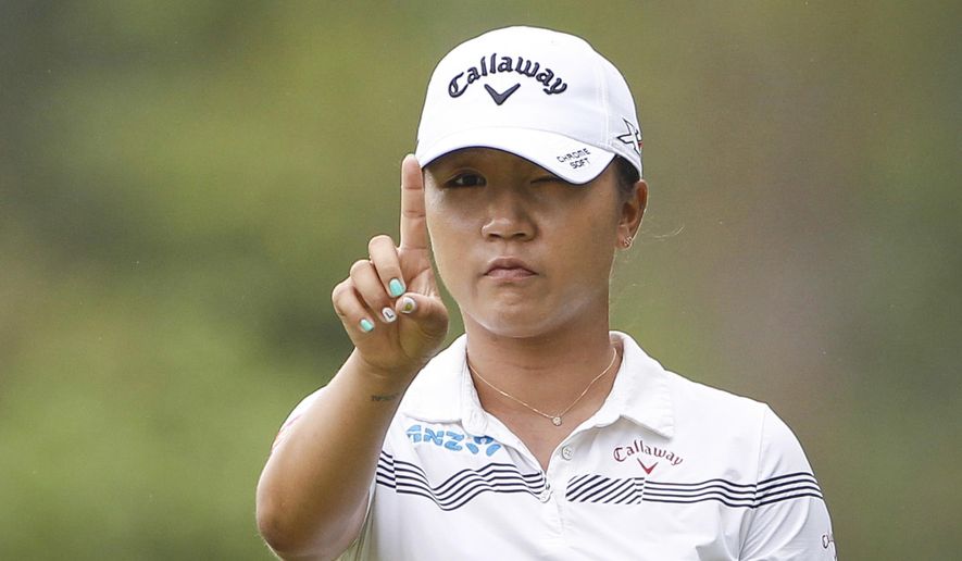 FILE - In this Oct. 28, 2016 file photo, Lydia Ko of New Zealand checks her line on the eleventh green during the second round of the LPGA golf tournament at Tournament Players Club (TPC) in Kuala Lumpur, Malaysia. A day ahead of the start of the Women's Australian Open at Royal Adelaide, the 21-year-old Thai golfer Ariya Jutanugarn also says she's not putting pressure on herself to overtake Ko for the No. 1 ranking. (AP Photo/Joshua Paul, File)