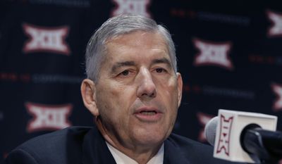 FILE - In this Oct. 17, 2016, file photo, Big 12 Commissioner Bob Bowlsby speaks to reporters after The Big 12 Conference meeting in Grapevine, Texas. The head of the NCAA&#39;s football oversight committee and the leader of the American Football Coaches Association are against delaying until the end of next season the expansion of FBS coaching staffs to 10 members. Bowlsby, chairman of the oversight committee, and Todd Berry, executive director of the AFCA, acknowledged hiring when staffs are typically set could inconvenience some schools. Still, they say it is not worth waiting.(AP Photo/LM Otero, File)
