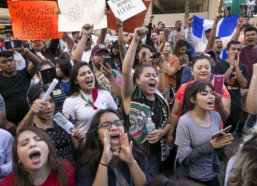 Hundreds protest recent ICE raids in Austin, Texas, at the J.J. Pickle Federal Building in Austin during the "Day Without Immigrants" on Thursday, Feb. 16, 2017. Immigrants around the U.S. stayed home from work and school Thursday to demonstrate how important they are to Americas economy, and many businesses closed in solidarity, in a nationwide protest called A Day Without Immigrants. (Jay Janner/Austin American-Statesman via AP)