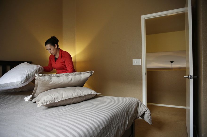 Jennifer Mesa cleans up a bedroom in the home of Randy Tussing, an Airbnb host, in preparation for guests, Thursday, Feb. 16, 2017, in Las Vegas. More than 340,000 people passed on Nevada&#x27;s hotel rooms last year and opted instead to book a place to stay using the home-sharing service Airbnb. The $47 million in revenue that hosts took in is a loss for the state&#x27;s hospitality industry that one expert says will only increase if not addressed. (AP Photo/John Locher)