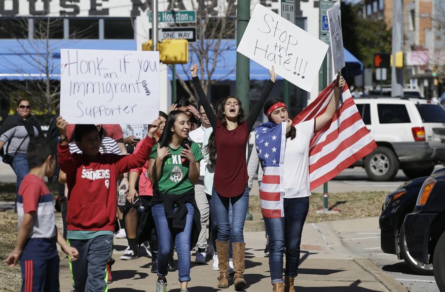 Immigrant supporters marches with others during a protest outside the Grayson County courthouse in downtown Sherman, Texas, Thursday, Feb. 16, 2017. In an action called "A Day Without Immigrants," immigrants across the country are expected to stay home from school, work and close businesses to show how critical they are to the U.S. economy and way of life. (AP Photo/LM Otero)