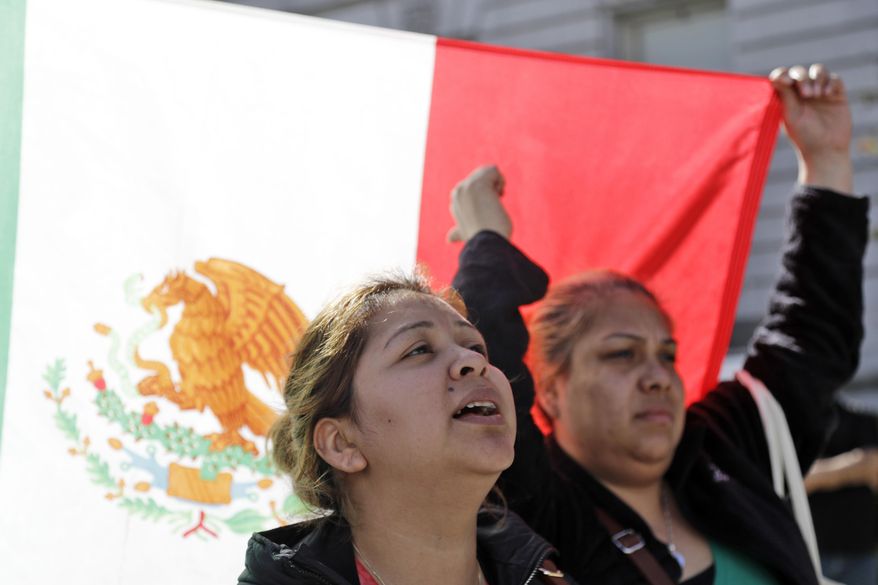 Mahena Tula, left, and her friend Maria Rios shout slogans during a protest against President Donald Trump's efforts to crack down on immigration Thursday, Feb. 16, 2017, in San Francisco. Immigrants around the country have been staying home from work and school today, hoping to demonstrate their importance to America's economy and its way of life. (AP Photo/Marcio Jose Sanchez)