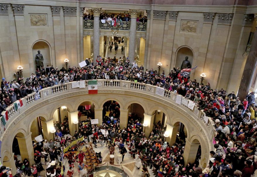 A large crowd of "A Day Without Immigrants," participants filled much of the inside of the Minnesota State Capitol Thursday, Feb. 16, 2017, in St. Paul, Minn. Immigrants around the U.S. stayed home from work and school Thursday to demonstrate how important they are to America’s economy and way of life, and many businesses closed in solidarity, in a nationwide protest called A Day Without Immigrants. (David Joles/Star Tribune via AP)