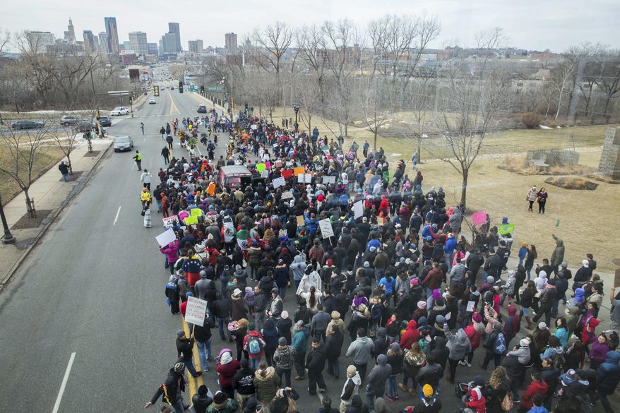 Marchers head down east 7th Street from the Mexican consulate to the State Capitol during a "A Day Without Immigrants" protest Thursday, Feb. 16, 2017, in St. Paul, Minn. It was part of a nationwide rally designed to show how important immigrants are to daily life. (Evan Frost/Minnesota Public Radio via AP)
