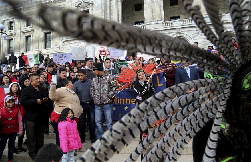 Participants in the "Day Without Immigrants," including members of Mexica Yolotl, a traditional Aztec group of Mexico-American dancers and drummers from the Twin Cities, fill the steps outside the Minnesota State Capitol Thursday, Feb. 16, 2017, in St. Paul, Minn. Immigrants around the U.S. stayed home from work and school Thursday to demonstrate how important they are to America’s economy and way of life, and many businesses closed in solidarity, in a nationwide protest called A Day Without Immigrants. (David Joles/Star Tribune via AP)