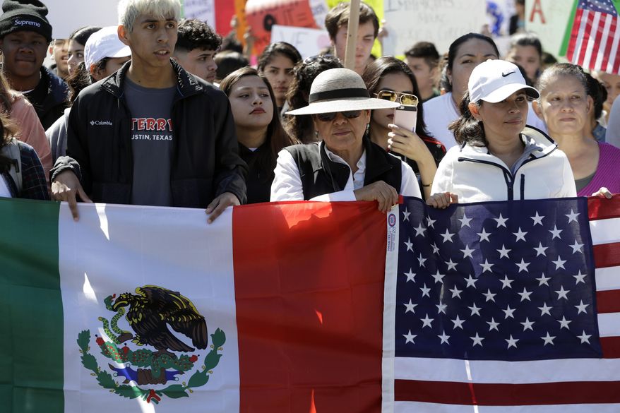 A group marches away from the Texas Capitol during an immigration protest, Thursday, Feb. 16, 2017, in Austin, Texas. Immigrants around the U.S. stayed home from work and school Thursday to demonstrate how important they are to America's economy and way of life, and many businesses closed in solidarity, in a nationwide protest called A Day Without Immigrants. (AP Photo/Eric Gay)