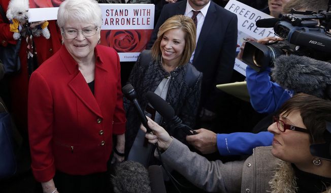 Barronelle Stutzman, left, a Richland, Wash., florist who was fined for denying service to a gay couple in 2013, smiles as she is surrounded by supporters after a hearing before Washington&#x27;s Supreme Court in Bellevue, Wash. (AP Photo/Elaine Thompson, File)