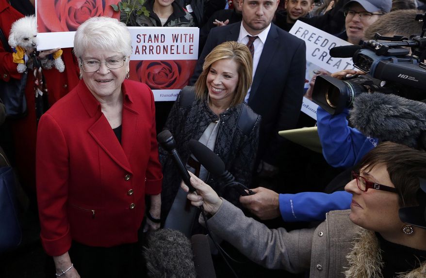 Barronelle Stutzman, left, a Richland, Wash., florist who was fined for denying service to a gay couple in 2013, smiles as she is surrounded by supporters after a hearing before Washington's Supreme Court in Bellevue, Wash. (AP Photo/Elaine Thompson, File)