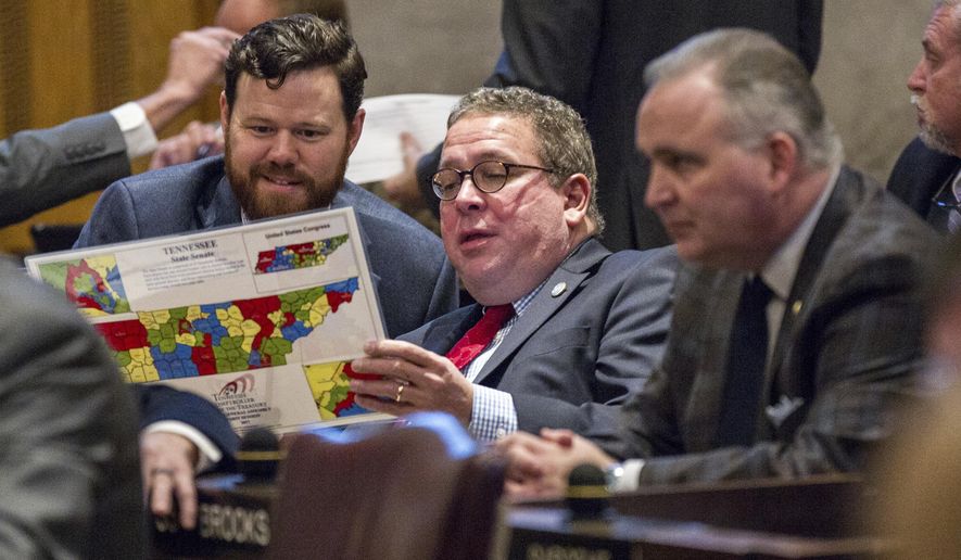 Rep. Gerald McCormick, R-Chattanooga, center, and Rep. Michael Curcio, R-Dickson, left look at a district map during a House floor session in Nashville, Tenn., on Thursday, Feb. 16, 2017. At right is Rep. Kevin Brooks, R-Cleveland. (AP Photo/Erik Schelzig)