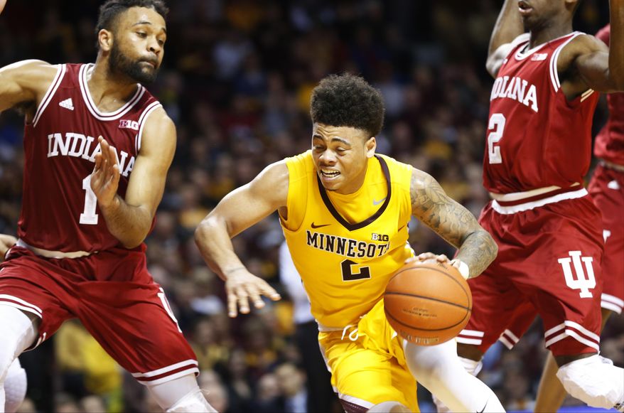 Minnesota's Nate Mason, center, drives around Indiana's James Blackmon Jr., left, during the second half of an NCAA college basketball game Wednesday, Feb. 15, 2017, in Minneapolis. Minnesota won 75-74. Mason led Minnesota with 30 points while Blackmon led Indiana with 22 points. (AP Photo/Jim Mone)