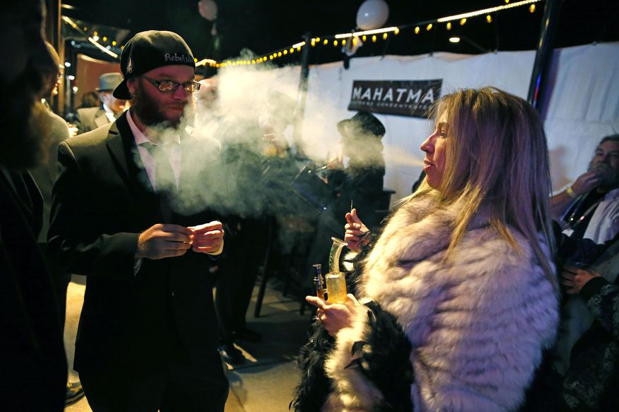 Partygoers smoke marijuana during a Prohibition-era themed New Year&#39;s Eve invite-only party celebrating the start of retail pot sales, at a bar in Denver, in this Dec. 31, 2013, file photo. Colorado is on the brink of becoming the first state with licensed pot clubs. Denver officials are working on regulations to open a one-year pilot of bring-your-own marijuana clubs. (AP Photo/Brennan Linsley, File)