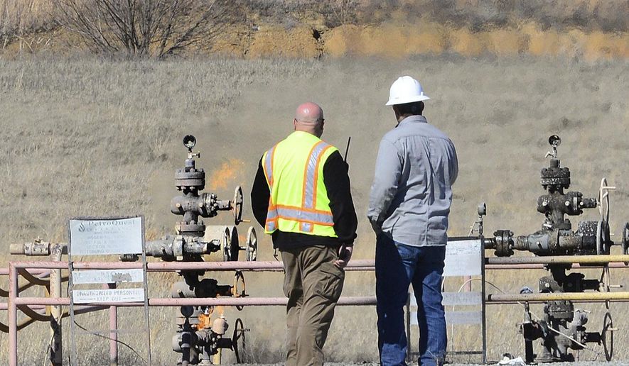 Kevin Enloe, director of McAlester/Pittsburg County Emergency Management, left, stands near the scene of an oil field explosion near Quinton, Okla., in Pittsburg County, Thursday, Feb. 16, 2017. (Kevin Harvison/The McAlester News-Capital via AP)