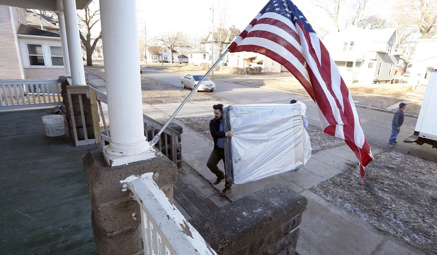 In a Tuesday, Feb. 14, 2017 photo, Chris Jung, left, and Jeff Carlson, both with Slumberland Furniture, unload new mattresses donated by Slumberland to the Americans For Independent Living Veterans house in Waterloo, Iowa. The homeless shelter for veterans is expected to be open this month, thanks to donations from several sources. (Brandon Pollock/The Courier via AP)