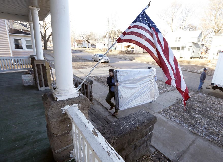 In a Tuesday, Feb. 14, 2017 photo, Chris Jung, left, and Jeff Carlson, both with Slumberland Furniture, unload new mattresses donated by Slumberland to the Americans For Independent Living Veterans house in Waterloo, Iowa. The homeless shelter for veterans is expected to be open this month, thanks to donations from several sources. (Brandon Pollock/The Courier via AP)