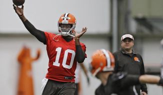 FILE - In this April 29, 2014, file photo, then-Cleveland Browns quarterback Vince Young throws during a voluntary minicamp workout at the team&#39;s NFL football training facility in Berea, Ohio. Vince Young still isn&#39;t quite ready to call it a career. The two-time Pro Bowl quarterback has hired agent Leigh Steinberg, who welcomed his new client on Twitter on Wednesday, Feb. 15, 2017, and said Young &amp;quot;has dream of playing more football, being role model.&amp;quot; (AP Photo/Mark Duncan, File)