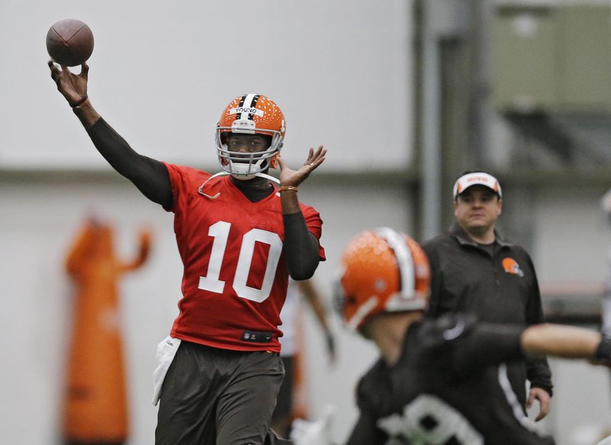 FILE - In this April 29, 2014, file photo, then-Cleveland Browns quarterback Vince Young throws during a voluntary minicamp workout at the team's NFL football training facility in Berea, Ohio. Vince Young still isn't quite ready to call it a career. The two-time Pro Bowl quarterback has hired agent Leigh Steinberg, who welcomed his new client on Twitter on Wednesday, Feb. 15, 2017, and said Young "has dream of playing more football, being role model." (AP Photo/Mark Duncan, File)