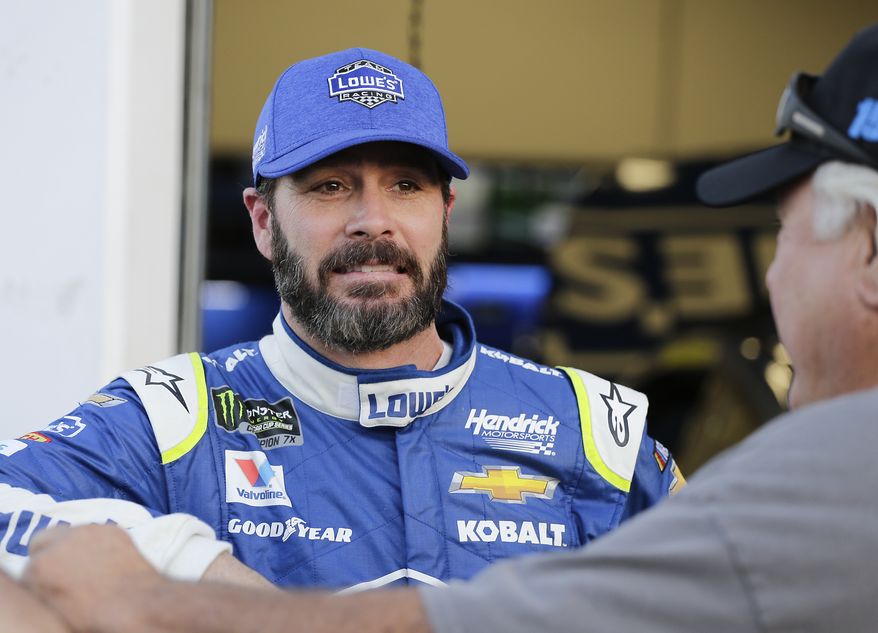 Jimmie Johnson, left, talks with a team member outside his garage during a practice session for the Clash NASCAR auto race at Daytona International Speedway, Friday, Feb. 17, 2017, in Daytona Beach, Fla. (AP Photo/Terry Renna) **FILE**