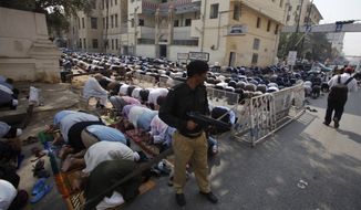A Pakistani police officer stands guard during a Friday&#39;s prayers in Karachi, Pakistan, Feb. 17, 2017. Pakistani forces killed and arrested dozens of suspects in sweeping raids overnight and into Friday, a day after a massive suicide bombing by the Islamic State group killed dozens of worshippers at a famed Sufi shrine in the country&#39;s south. (AP Photo/Fareed Khan)