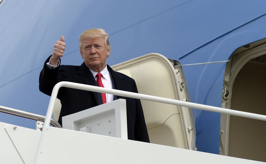 President Donald Trump gives a thumbs-up from the top of the steps of Air Force One at Andrews Air Force Base in Md., Friday, Feb. 17, 2017. Trump is visiting the Boeing South Carolina facility to see the Boeing 787 Dreamliner before heading to his Mar-a-Lago estate in Palm Beach, Fla., for the weekend. (AP Photo/Susan Walsh)