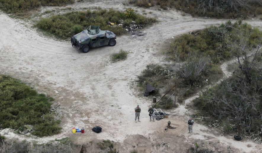 FILE - In this Feb. 24, 2015, file photo, members of the National Guard patrol along the Rio Grande at the Texas-Mexico border in Rio Grande City, Texas. The Trump administration is considering a proposal to mobilize as many as 100,000 National Guard troops to round up unauthorized immigrants, including millions living nowhere near the Mexico border, according to a draft memo obtained by The Associated Press. (AP Photo/Eric Gay, File)
