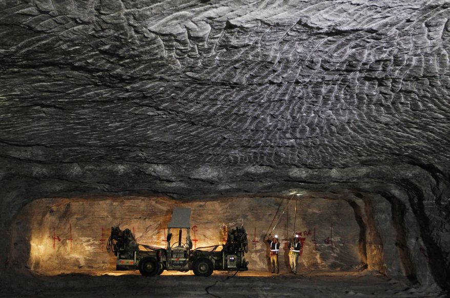 In this Jan. 27, 2017 photo, American Rock Salt Co. workers use hand scalers to remove loose roof material at the mine in Hampton Corners, N.Y. Deep below upstate New York’s farm country, workers in ghostly tunnels are praying for snow. Fiercer winters mean better business, longer hours and fatter paychecks at what’s billed as the nation’s most productive salt mine, which ships trainloads of snow-melting road salt to municipalities across the Northeast. (AP Photo/Jeffrey T. Barnes)