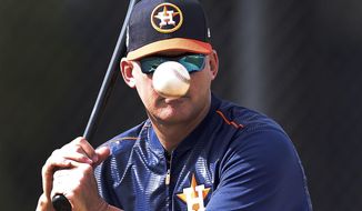 Houston Astros manager A.J. Hinch a hit balls to pitchers during a drill at spring baseball training in West Palm Beach, Fla, Thursday, Feb. 16, 2017. (Karen Warren/Houston Chronicle via AP)